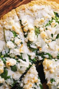 brown rice pizza crust topped with cheese and spinach