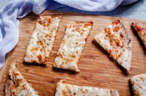 quinoa pizza crust on cutting board