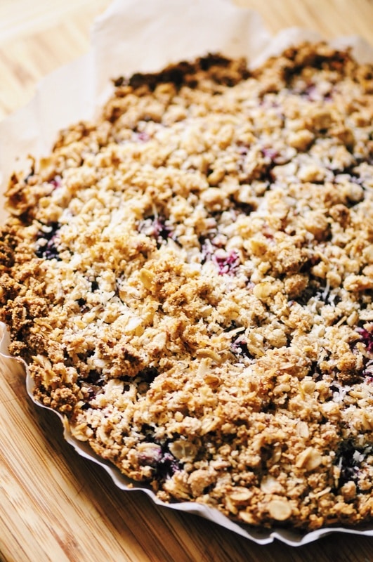  A luscious triple berry filling atop a crisp crust & topped with a delightful coconut crumble makes for one easy, healthy and delicious gluten-free and vegan dessert! #berrycrumble #vegan #glutenfree #coconut #oat #almondcrust #healthydessert #refinedsugarfree 