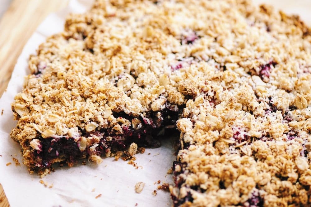  A luscious triple berry filling atop a crisp crust & topped with a delightful coconut crumble makes for one easy, healthy and delicious gluten-free and vegan dessert! #berrycrumble #vegan #glutenfree #coconut #oat #almondcrust #healthydessert #refinedsugarfree 