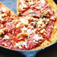 socca pizza with red sauce and feta