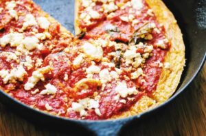 socca pizza with red sauce and feta