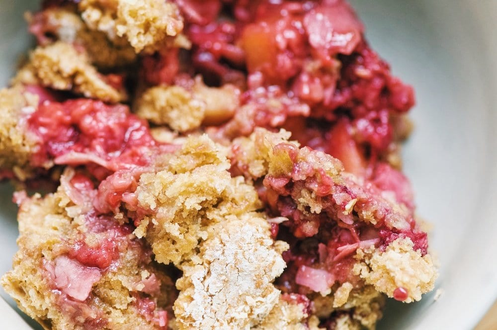 Close shot of pink berries and cobbler dough.