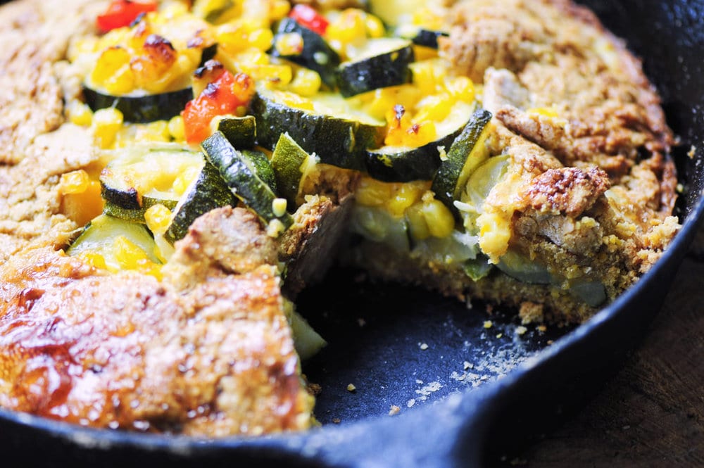  An easy and delicious gluten-free galette filled with a beautiful zucchini based calabacitas packed with corn, chiles, onion, garlic & cheese, and enveloped in a rustic chickpea flour and polenta crust. 