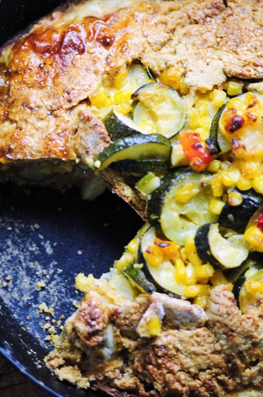  An easy and delicious gluten-free galette filled with a beautiful zucchini based calabacitas packed with corn, chiles, onion, garlic & cheese, and enveloped in a rustic chickpea flour and polenta crust. 