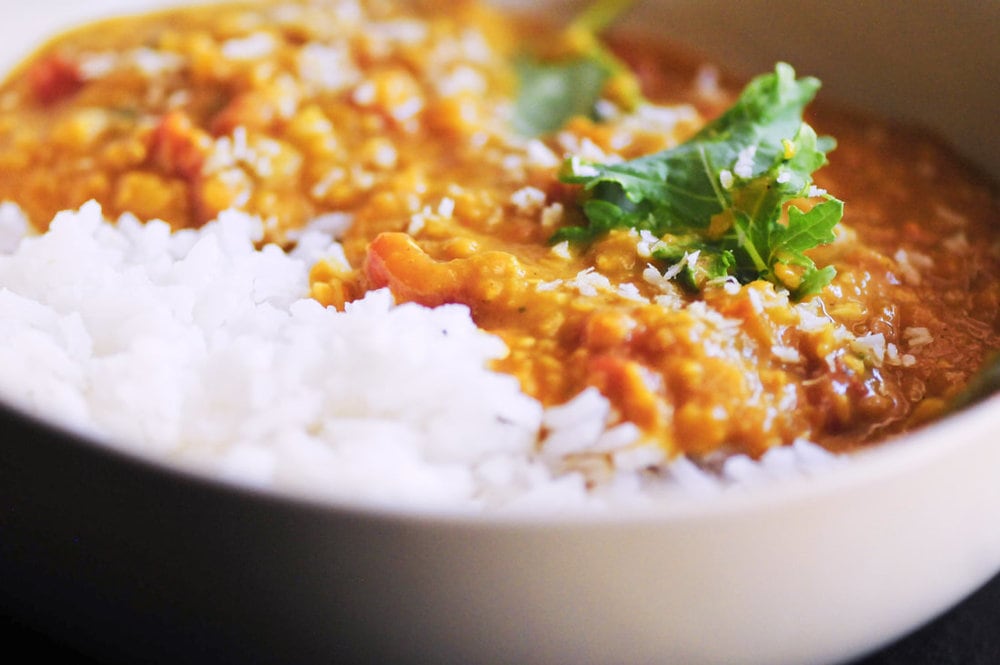  Cozy up with this quick, easy, & tasty one pot spicy coconut dal made with red lentils, coconut milk, tomatoes, garlic, onion and the perfect blend of Indian spices. It makes a most delicious gluten-free, vegan dish served alongside some basmati rice or naan bread! #dal #dhal #daal #indianfood #curry #vegancurry #glutenfree #spicyfood #coconutcurry #redlentils 