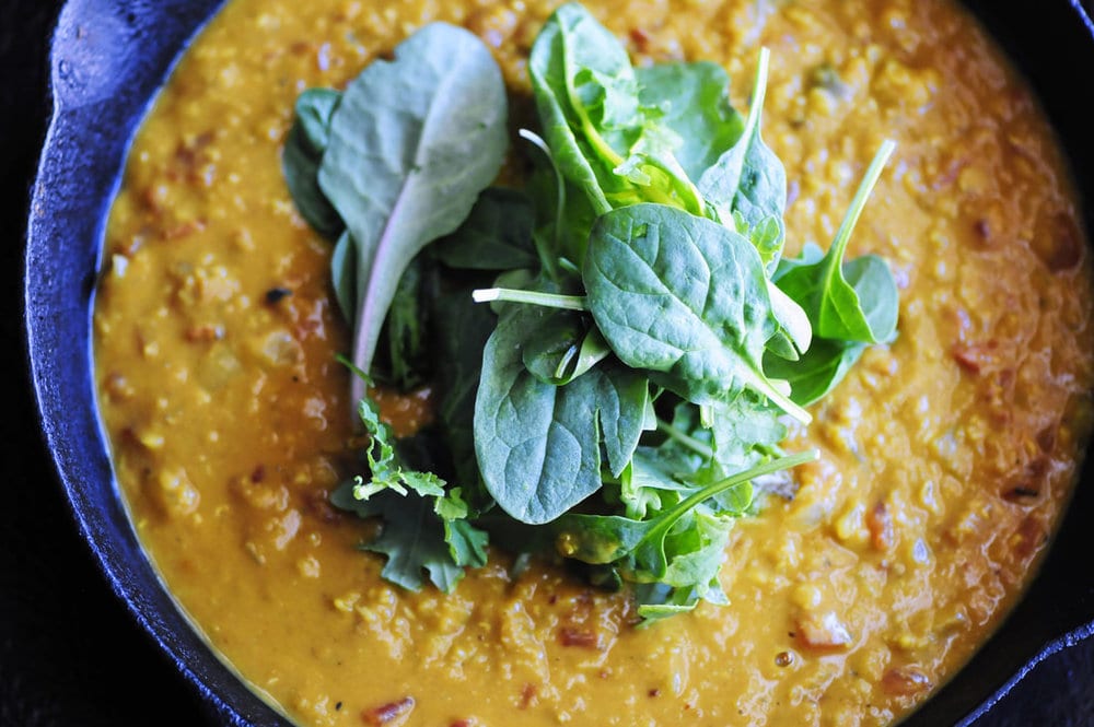  Cozy up with this quick, easy, & tasty one pot spicy coconut dal made with red lentils, coconut milk, tomatoes, garlic, onion and the perfect blend of Indian spices. It makes a most delicious gluten-free, vegan dish served alongside some basmati rice or naan bread! #dal #dhal #daal #indianfood #curry #vegancurry #glutenfree #spicyfood #coconutcurry #redlentils 