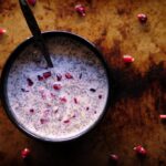 pomegranate pudding in a black bowl