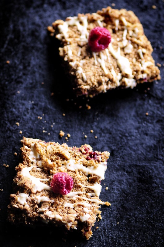  These Raspberry Gingerbread Crumble Bars are made with a delectably spiced buttery oat crust filled with a luscious raspberry chia seed jam and then drizzled with white chocolate! They make for one beautiful, easy, delicious and festive gluten-free treat! #raspberrybars #gingerbreadbars #glutenfreebars #gingerbread #chiaseedbars #whitechocolate #chiajam 