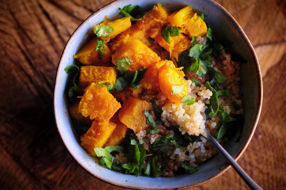  This tasty quinoa bowl with spicy roasted pumpkin is gently spiced by ginger, turmeric, and red chili flakes. It is easy, nutritious and delicious; and makes a hearty & filling gluten-free vegan meal! #roastedpumpkin #quinoabowl #glutenfreeveganmeal #healthydinner #spicypumpkin #autumn 