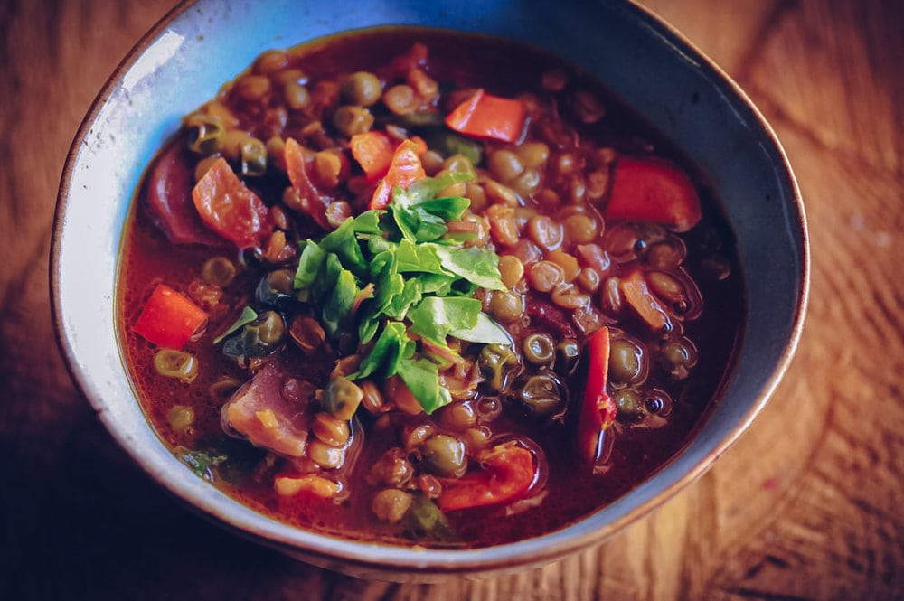  A hearty and nourishing gluten-free & vegan soup chock-full of lentils, beets, peas, bell peppers, garlic, onion, and mixed greens! Throw in the perfect blend of delicious spices and you have one healthy, filling, delicious, easy, and comforting meal ready for a Winter's eve. #beetsoup #wintersoup #lentilsoup #peasoup #comfortfood #glutenfreevegan 