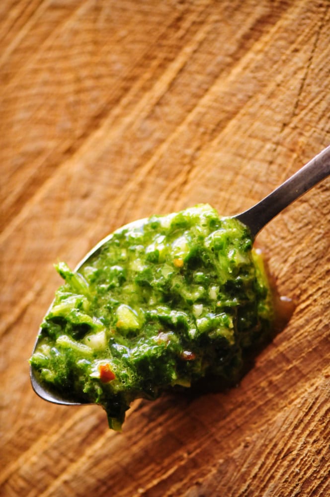  This quick and easy 9 ingredient Chimichurri Verde is my spin on the classic South American sauce! It contains a blend of parsley, cilantro, garlic, oil, vinegar and spices; and is BIG on flavor. You'll find yourself putting this delicious gluten-free & vegan sauce on everything -- this I can attest! #chimichurri #chimichurrisauce #chimichurriverde #southamerican #green #condiment #cilantrosauce #parsleysauce 