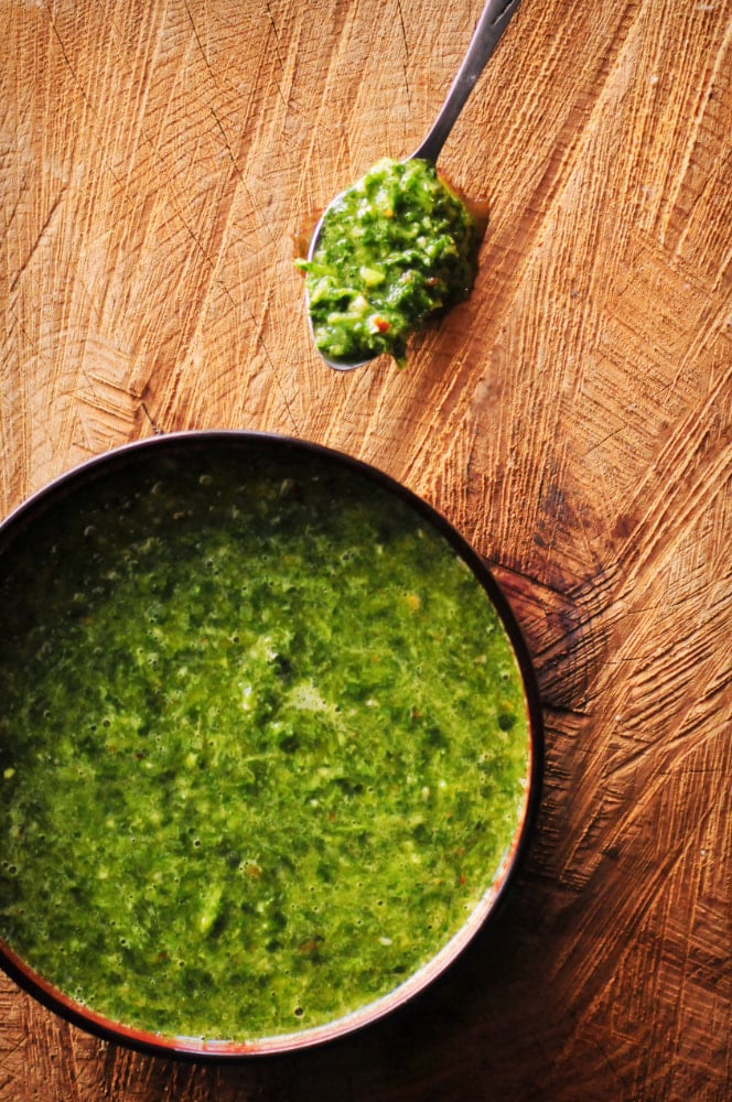  This quick and easy 9 ingredient Chimichurri Verde is my spin on the classic South American sauce! It contains a blend of parsley, cilantro, garlic, oil, vinegar and spices; and is BIG on flavor. You'll find yourself putting this delicious gluten-free & vegan sauce on everything -- this I can attest! #chimichurri #chimichurrisauce #chimichurriverde #southamerican #green #condiment #cilantrosauce #parsleysauce 