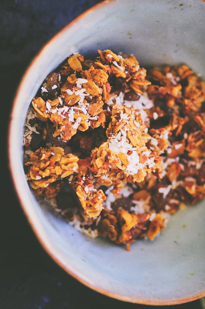 Close shot of orange colored granola sprinkled with white coconut.