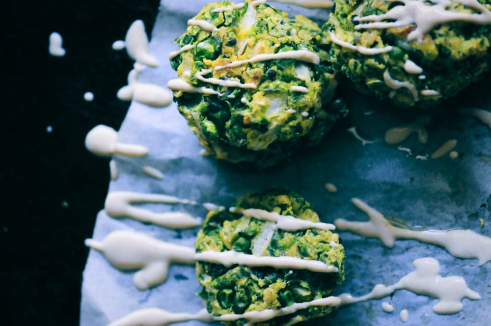  These easy, healthy, and delicious Baked Spring Pea and Dill Fritters with Lemon Tahini Sauce make a great gluten-free & vegan appetizer, snack, or meal! #peafritters #glutenfreefritters #veganfritters #greenfritters #dillfritters #lemontahinisauce 