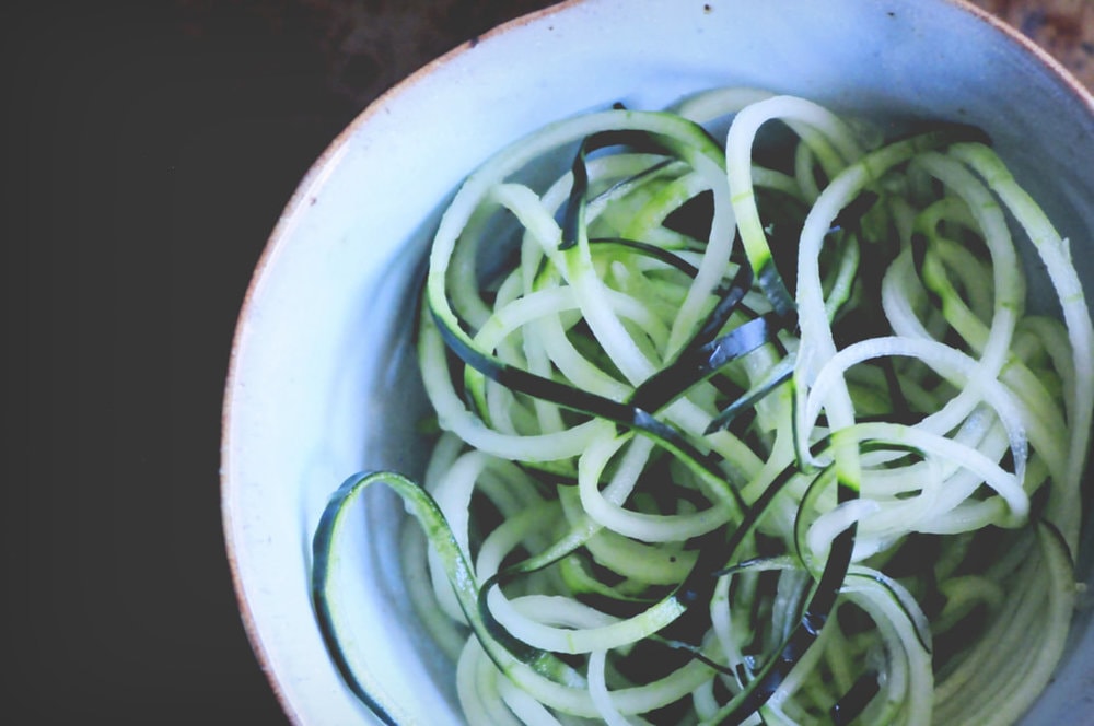  A refreshing, light, healthy and easy spiralized cucumber noodle dish served alongside a spicy turmeric tahini sauce and garnished with bell pepper for a delightful crunch. Gluten-free, vegan, and oh so delicious! #spiralizedcucumber #cucumbernoodles #turmerictahinisauce #spicycucumbernoodles #zoodles 