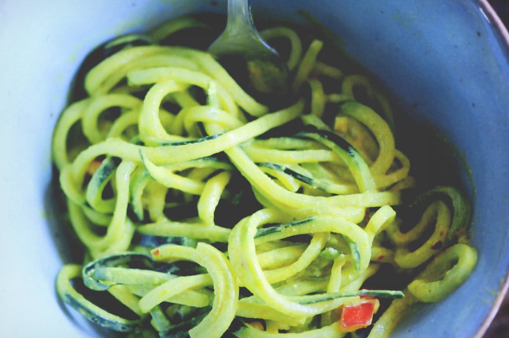  A refreshing, light, healthy and easy spiralized cucumber noodle dish served alongside a spicy turmeric tahini sauce and garnished with bell pepper for a delightful crunch. Gluten-free, vegan, and oh so delicious! #spiralizedcucumber #cucumbernoodles #turmerictahinisauce #spicycucumbernoodles #zoodles 