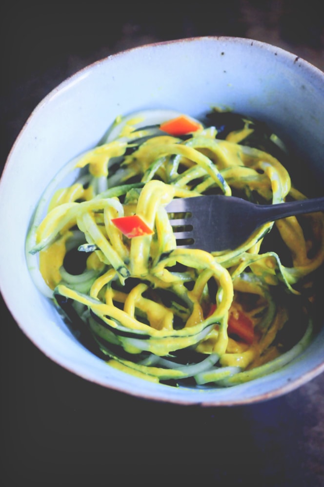  A refreshing, light, healthy and easy spiralized cucumber noodle dish served alongside a spicy turmeric tahini sauce and garnished with bell pepper for a delightful crunch. Gluten-free, vegan, and oh so delicious! #spiralizedcucumber #cucumbernoodles #turmerictahinisauce #spicycucumbernoodles #zoodles 
