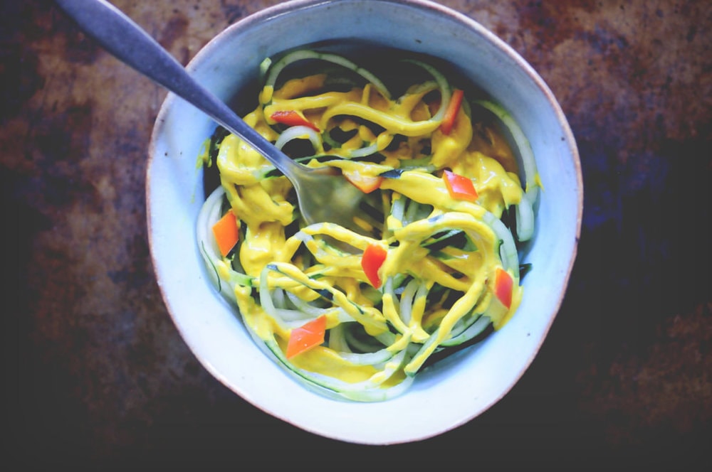  A refreshing, light, healthy and easy spiralized cucumber noodle dish served alongside a spicy turmeric tahini sauce and garnished with bell pepper for a delightful crunch. Gluten-free, vegan, and oh so delicious! #spiralizedcucumber #cucumbernoodles #turmerictahinisauce #spicycucumbernoodles #zoodles 