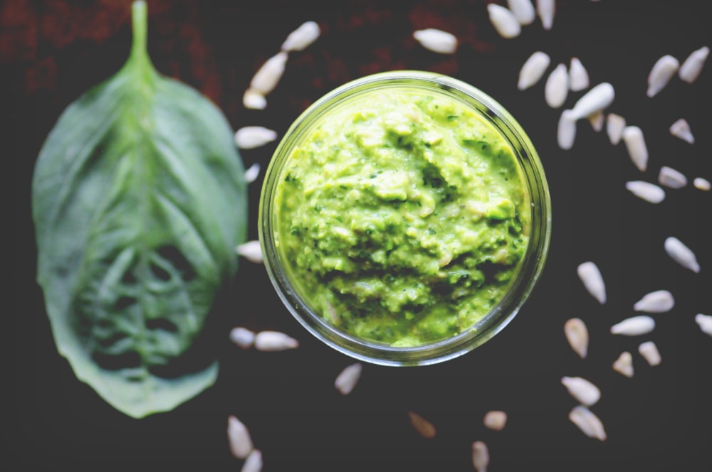  A gluten-free and vegan Sunny Spring Pea & Basil Pesto made with spring peas, fresh basil, mixed greens, sunflower seeds, garlic, and lemon juice. This delicious pesto is easy, healthy, and DELICIOUS! #veganpesto #springpesto #peapesto #basilpesto 