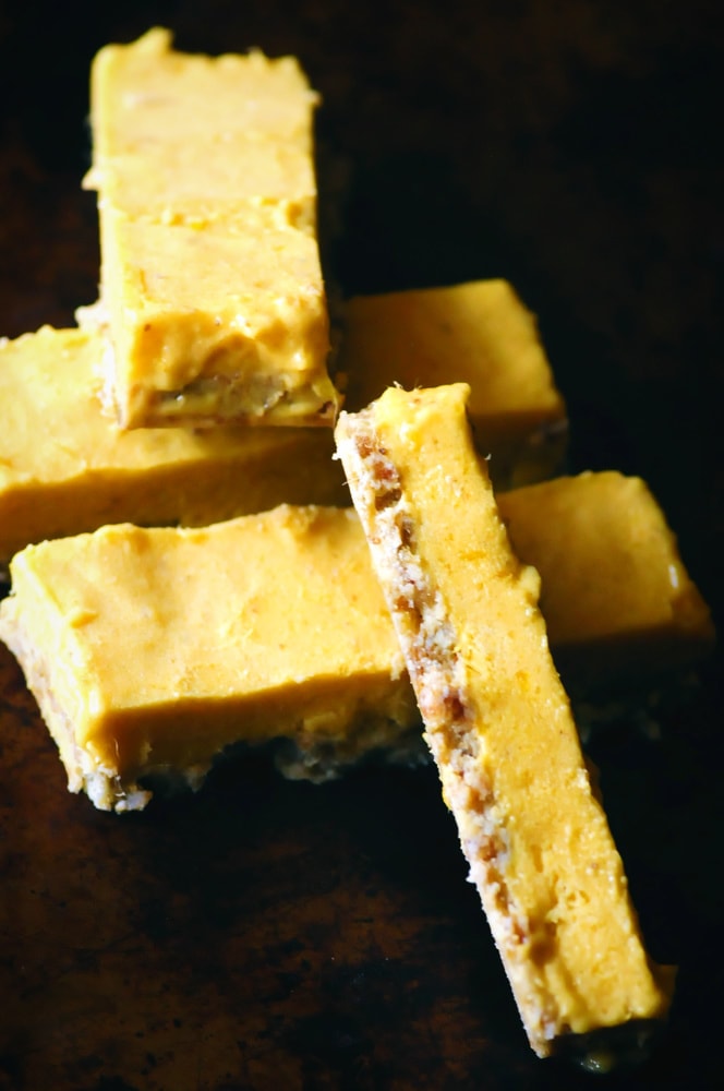  These date-free Vegan & Gluten-Free Mango Nice Cream Bars make for one easy, healthy, delicious, and refreshing frozen treat! A creamy frozen mango banana ice cream filling sits atop a chewy cardamom almond crust in this delightful dessert. #veganicecreambars #nicecream #nicecreambars #rawbars #veganbars #mangobars #mangonicecream #glutenfreeicecreambars 
