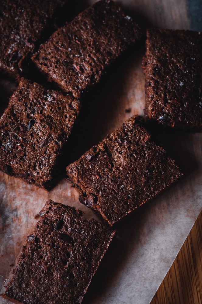  These easy and delicious Chai-Spiced Cacao Nib Brownie Bars are delightfully chocolate-y, subtly spiced, packed with iron, fiber and potassium from the cocoa nibs as well as having a diving texture. This gluten-free treat makes a great breakfast, snack or dessert as it is not over-the-top sweet (but big on flavor!). #cacaonibs #cocoa #chocolatebars #chaispiced #glutenfreebrownies #glutenfreebars #chaibars #glutenfreecakebrownies #chaispicedbrownies 