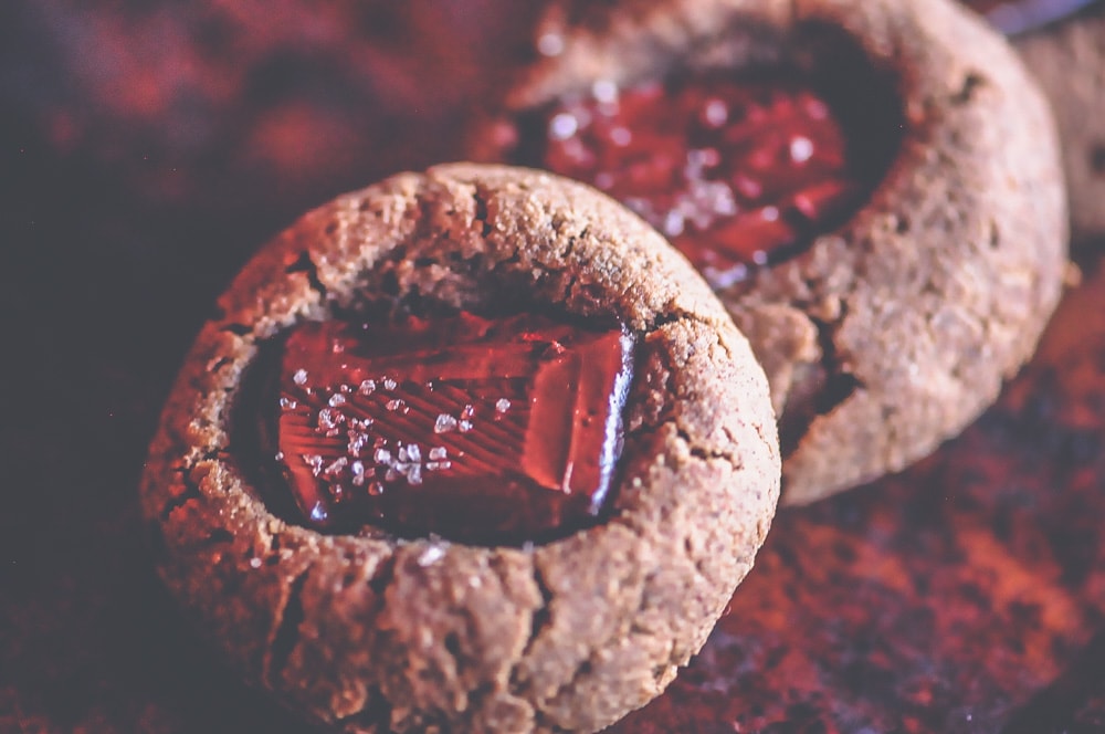  Perfectly soft, chewy and pillowy Gluten-Free Thumbprint Cookies made with coconut flour, cacao powder, chocolate chunks, almond butter and a dusting of sea salt. These delicious cookies are easy to make, free of refined sugar and make a great healthy treat any time of the day! #thumbprintcookies #glutenfreecookies #glutenfreethumbprintcookies #coconutflour #coconutflourcookies #almondbuttercookies #chocolatechunk 