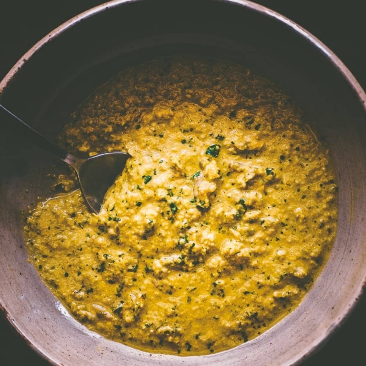 Yellow sauce in a ceramic bowl.