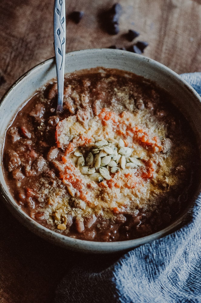  This easy vegan Instant Pot chili recipe is filled with spicy and smoky chipotle peppers, pinto beans and unsweetened chocolate lending this vegetarian chili a unique and flavorful twist. #instantpotchili #instantpotchilirecipe #instantpostvegetarianchili #instantpotchiliwithdrybeans #pintobeanchili #vegetarianchili #chocolatechili #veganchilie #Pressurecookerchili 