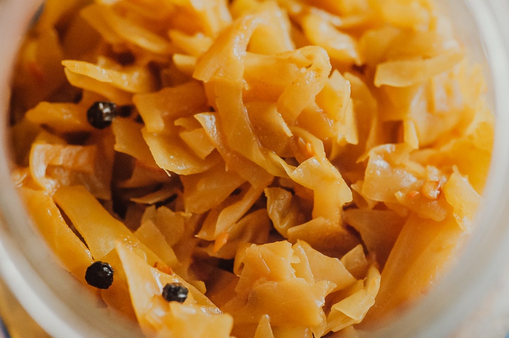  This probiotic rich Spicy Sauerkraut recipe with turmeric, red chili flakes, and black peppercorns is bursting with flavor and anti-inflammatory + gut health benefits! Easy, healthy, vegan, gluten-free and DELICIOUS! Learn all about how to make sauerkraut, health benefits, and more in this informative recipe post! #turmericsauerkraut #spicysauerkraut #howtomakesauerkraut 