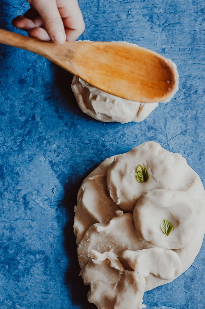  This natural homemade gluten-free playdough recipe is made with edible, non-toxic ingredients, including freshly harvested peppermint leaves for a fun sensory-rich play dough experience! Learn how to make this easy gluten-free play dough + learn all about the benefits of this healthy and beneficial indoor activity! This nature inspired crafts activity will please the pickiest of kids, + ease your worries with its safe and wholesome ingredients! #glutenfreeplaydough #edibleplaydough 