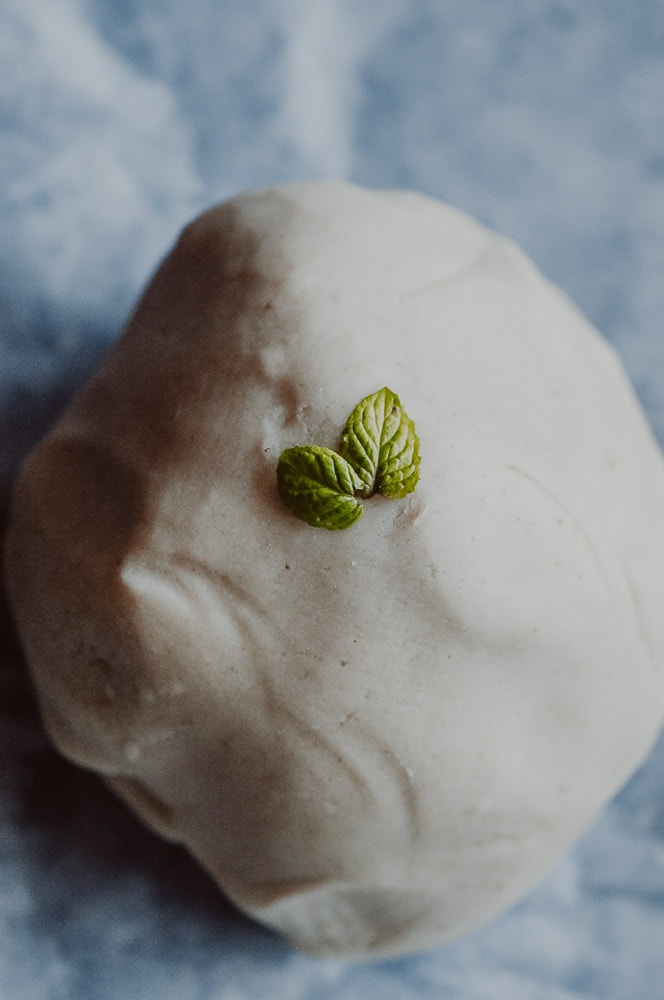  This natural homemade gluten-free playdough recipe is made with edible, non-toxic ingredients, including freshly harvested peppermint leaves for a fun sensory-rich play dough experience! Learn how to make this easy gluten-free play dough + learn all about the benefits of this healthy and beneficial indoor activity! This nature inspired crafts activity will please the pickiest of kids, + ease your worries with its safe and wholesome ingredients! #glutenfreeplaydough #edibleplaydough 