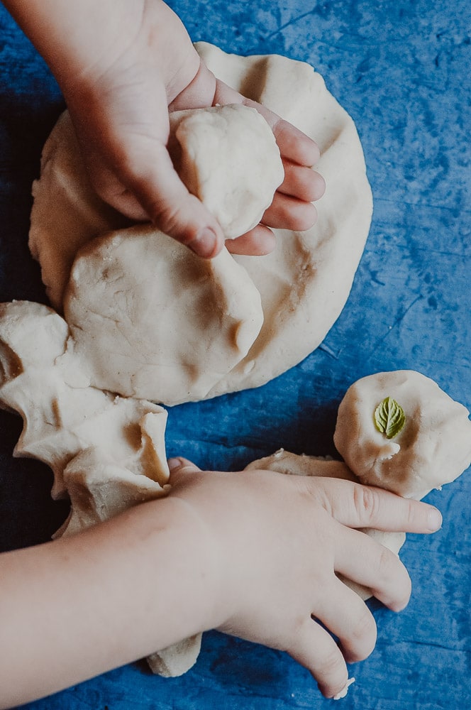  This natural homemade gluten-free playdough recipe is made with edible, non-toxic ingredients, including freshly harvested peppermint leaves for a fun sensory-rich play dough experience! Learn how to make this easy gluten-free play dough + learn all about the benefits of this healthy and beneficial indoor activity! This nature inspired crafts activity will please the pickiest of kids, + ease your worries with its safe and wholesome ingredients! #glutenfreeplaydough #edibleplaydough 