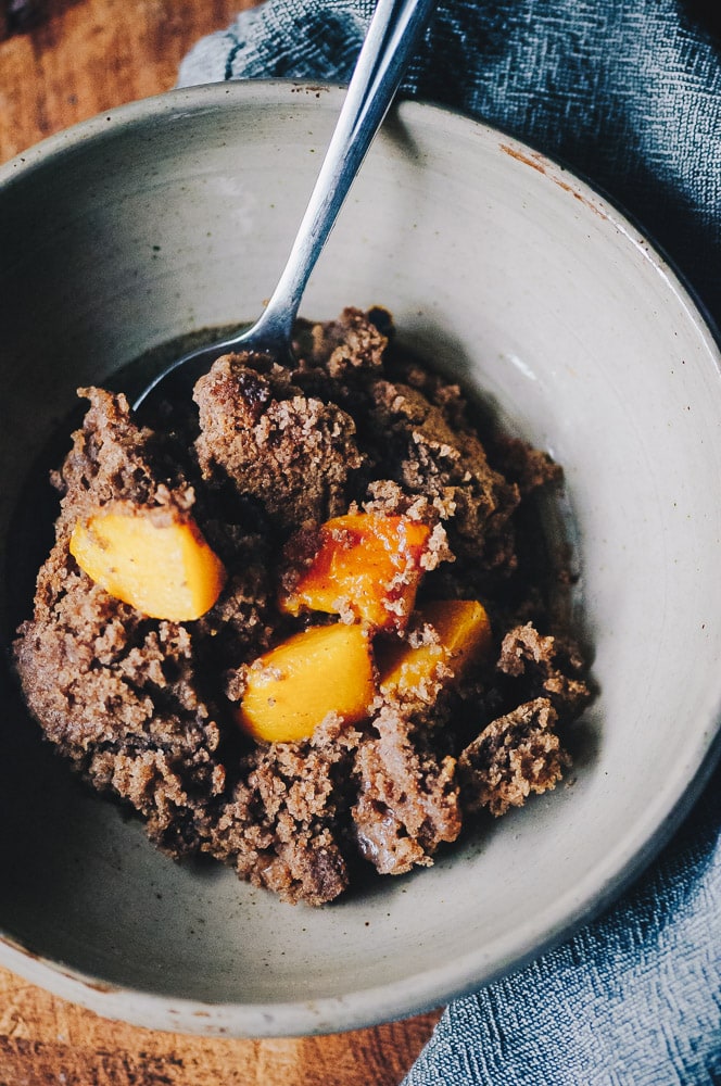   This easy and healthy gluten-free peach cobbler recipe is made with a blend of buckwheat and tapioca flours for a lovely flavor and texture that greatly complements juicy peaches for a heart-warming breakfast or dessert! Refined sugar-free with a dairy-free + vegan option! #glutenfreecobbler #glutenfreepeachcobbler #veganpeachcobbler #healthypeachcobbler  