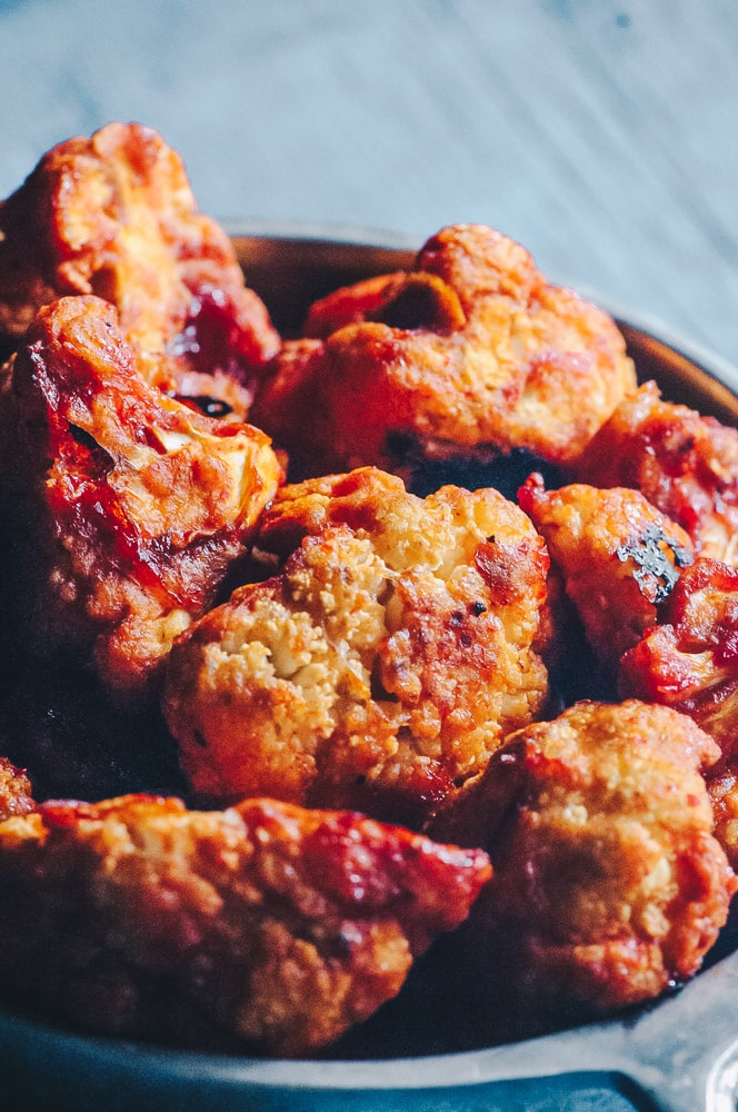  Super hearty and delicious Sweet and Spicy BBQ Cauliflower wings! These gluten-free vegan cauliflower bites are baked to perfection with a delightful spicy sweet sauce. Whether as a party appetizer or meal, these baked cauliflower wings are certain to impress! #cauliflowerwings #bbqcauliflowerwings #cauliflowerbites #vegancauliflowerwings #glutenfreecauliflowerwings 