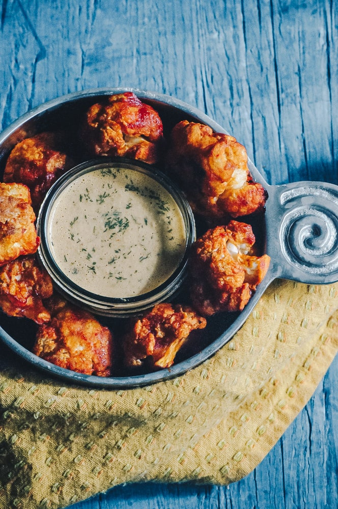  Super hearty and delicious Sweet and Spicy BBQ Cauliflower wings! These gluten-free vegan cauliflower bites are baked to perfection with a delightful spicy sweet sauce. Whether as a party appetizer or meal, these baked cauliflower wings are certain to impress! #cauliflowerwings #bbqcauliflowerwings #cauliflowerbites #vegancauliflowerwings #glutenfreecauliflowerwings 