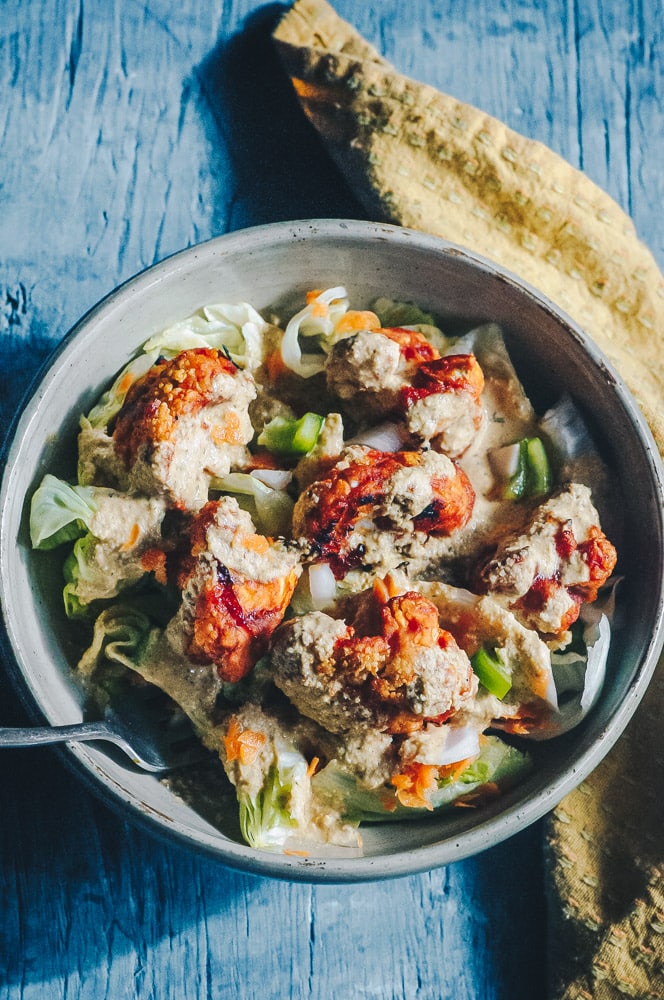   This delicious Roasted Cauliflower Salad makes for one healthy, easy, delicious and filling dish topped with a delightful Sweet and Spicy BBQ Roasted Cauliflower packed with loads of flavor and spice. Contrasted with fresh, crisp iceberg lettuce, and my pumpkin seed vegan ranch dressing, this vegan salad is a medley of pleasing textures, too! #roastedcauliflowersalad #bbqcauliflowersalad #cauliflowerwingsalad  