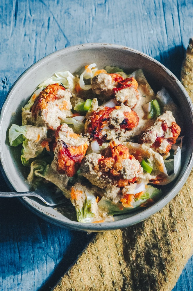   This delicious Roasted Cauliflower Salad makes for one healthy, easy, delicious and filling dish topped with a delightful Sweet and Spicy BBQ Roasted Cauliflower packed with loads of flavor and spice. Contrasted with fresh, crisp iceberg lettuce, and my pumpkin seed vegan ranch dressing, this vegan salad is a medley of pleasing textures, too! #roastedcauliflowersalad #bbqcauliflowersalad #cauliflowerwingsalad  