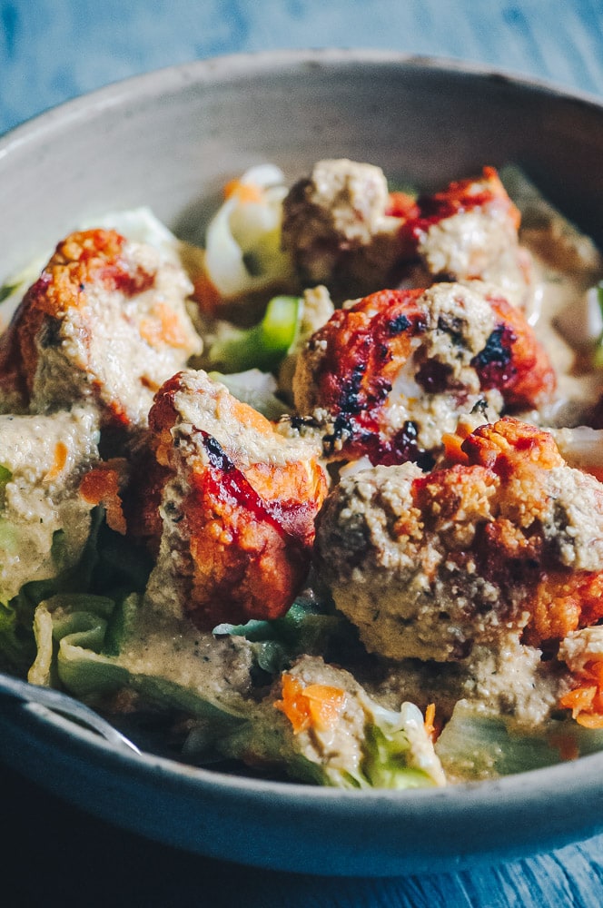   This delicious Roasted Cauliflower Salad makes for one healthy, easy, delicious and filling dish topped with a delightful Sweet and Spicy BBQ Roasted Cauliflower packed with loads of flavor and spice. Contrasted with fresh, crisp iceberg lettuce, and my pumpkin seed vegan ranch dressing, this vegan salad is a medley of pleasing textures, too! #roastedcauliflowersalad #bbqcauliflowersalad #cauliflowerwingsalad  