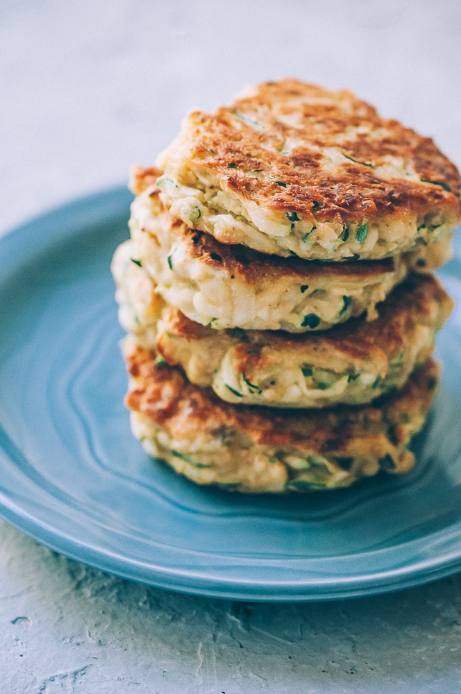  Super EASY, DELICIOUS AND HEALTHY Vegan Zucchini Fritters made with chickpea flour for that extra nutritional punch. These gluten-free vegan fritters are filled with loads of FLAVOR and could not be a tastier way to use that summer squash from your garden! #zucchinifritters #veganfritters #veganzucchinifritters #glutenfreezucchinifritters 
