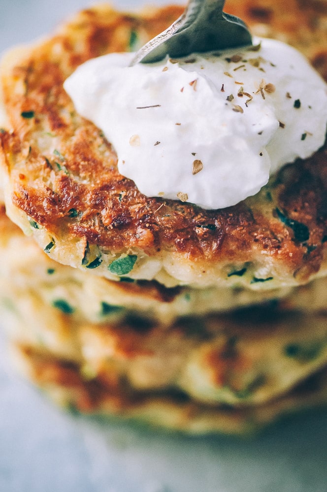  Super EASY, DELICIOUS AND HEALTHY Vegan Zucchini Fritters made with chickpea flour for that extra nutritional punch. These gluten-free vegan fritters are filled with loads of FLAVOR and could not be a tastier way to use that summer squash from your garden! #zucchinifritters #veganfritters #veganzucchinifritters #glutenfreezucchinifritters 