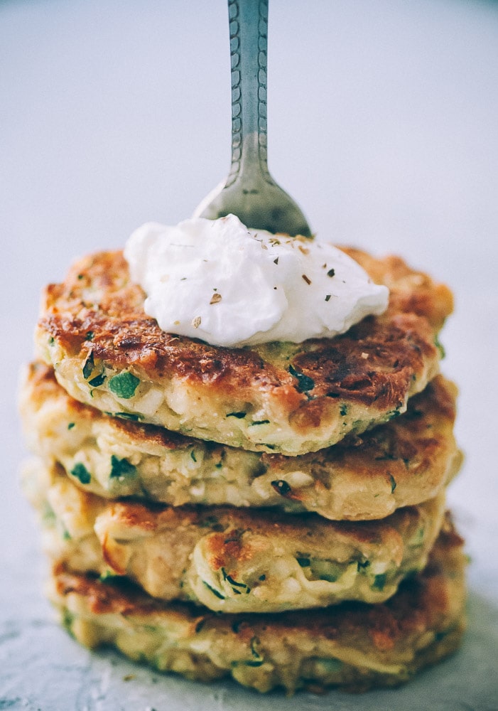  Super EASY, DELICIOUS AND HEALTHY Vegan Zucchini Fritters made with chickpea flour for that extra nutritional punch. These gluten-free vegan fritters are filled with loads of FLAVOR and could not be a tastier way to use that summer squash from your garden! #zucchinifritters #veganfritters #veganzucchinifritters #glutenfreezucchinifritters 