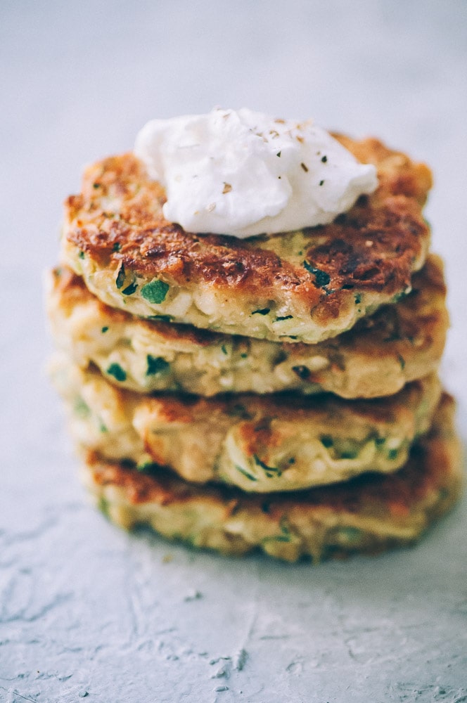  Super EASY, DELICIOUS AND HEALTHY Vegan Zucchini Fritters made with chickpea flour for that extra nutritional punch. These gluten-free vegan fritters are filled with loads of FLAVOR and could not be a tastier way to use that summer squash from your garden! #zucchinifritters #veganfritters #veganzucchinifritters #glutenfreezucchinifritters 