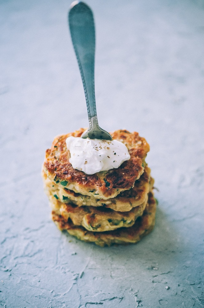  Super EASY, DELICIOUS AND HEALTHY Vegan Zucchini Fritters made with chickpea flour for that extra nutritional punch. These gluten-free vegan fritters are filled with loads of FLAVOR and could not be a tastier way to use that summer squash from your garden! #zucchinifritters #veganfritters #veganzucchinifritters #glutenfreezucchinifritters 