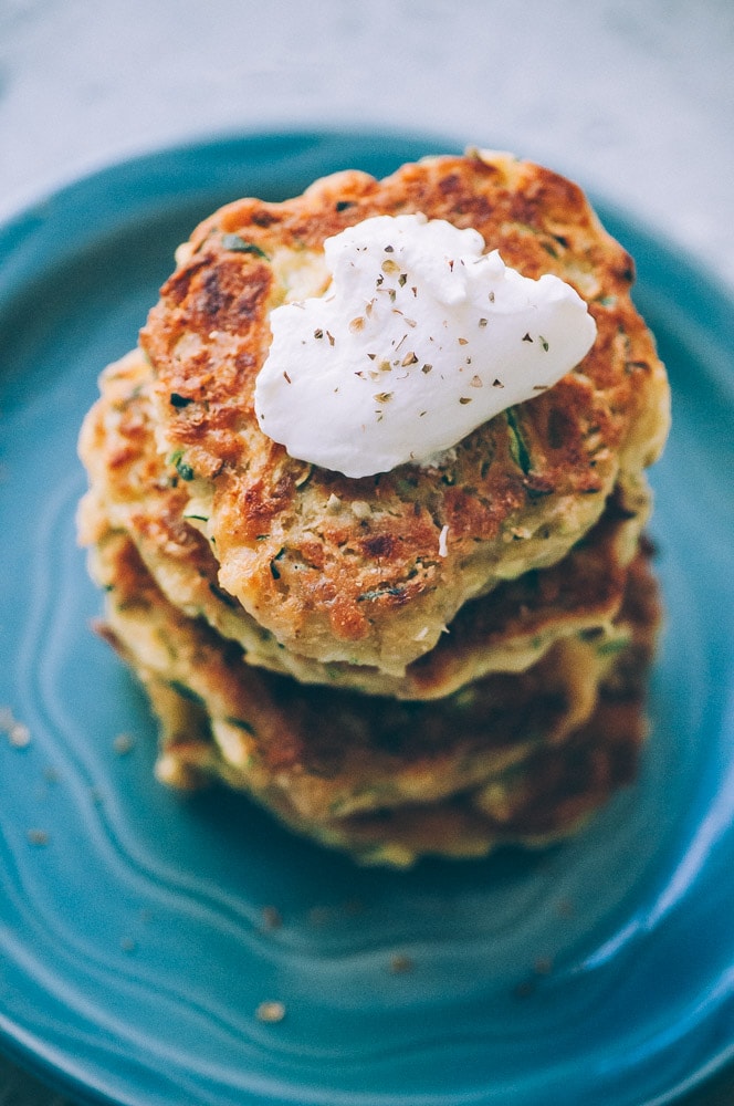  Super EASY, DELICIOUS AND HEALTHY Vegan Zucchini Fritters made with chickpea flour for that extra nutritional punch. These gluten-free vegan fritters are filled with loads of FLAVOR and could not be a tastier way to use that summer squash from your garden! #zucchinifritters #veganfritters #veganzucchinifritters #glutenfreezucchinifritters 