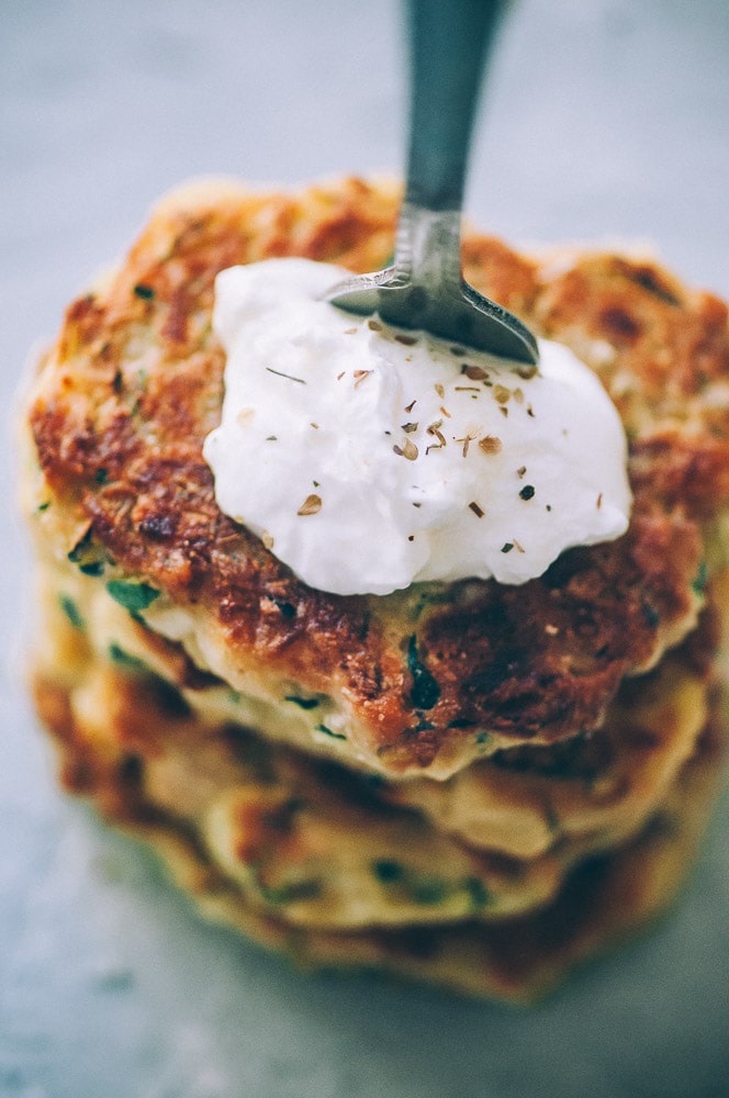  Super EASY, DELICIOUS AND HEALTHY Vegan Zucchini Fritters made with chickpea flour for that extra nutritional punch. These gluten-free vegan fritters are filled with loads of FLAVOR and could not be a tastier way to use that summer squash from your garden! #zucchinifritters #veganfritters #veganzucchinifritters #glutenfreezucchinifritters 