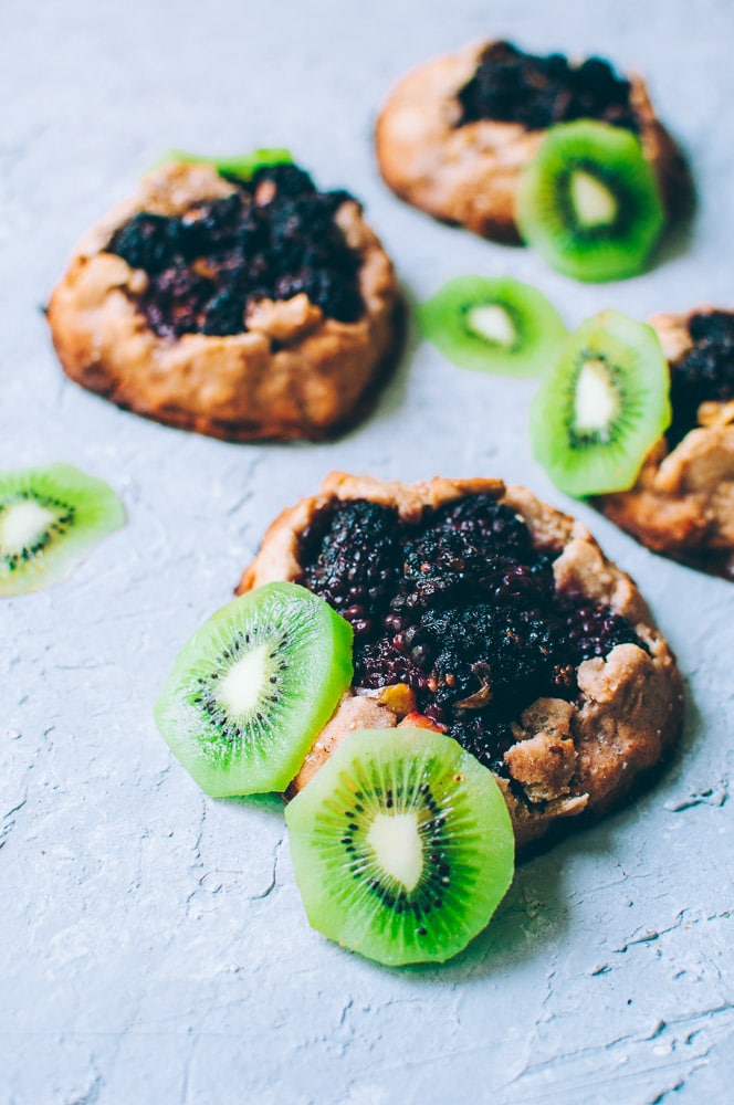  How-to make Mini Blackberry Kiwi Galettes -  These gluten-free vegan mini rustic pies are filled with juicy blackberries and tart kiwi for a fun twist! Easy, healthy, and delicious galettes are at your fingertips! #galette #galettes #minipies #rusticepies #kiwi #blackberries #glutenfreepie #veganpie #kiwipie  