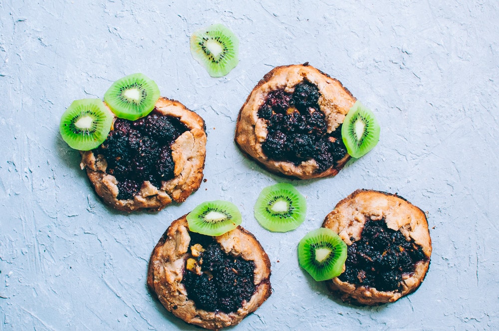  How-to make Mini Blackberry Kiwi Galettes -  These gluten-free vegan mini rustic pies are filled with juicy blackberries and tart kiwi for a fun twist! Easy, healthy, and delicious galettes are at your fingertips! #galette #galettes #minipies #rusticepies #kiwi #blackberries #glutenfreepie #veganpie #kiwipie  