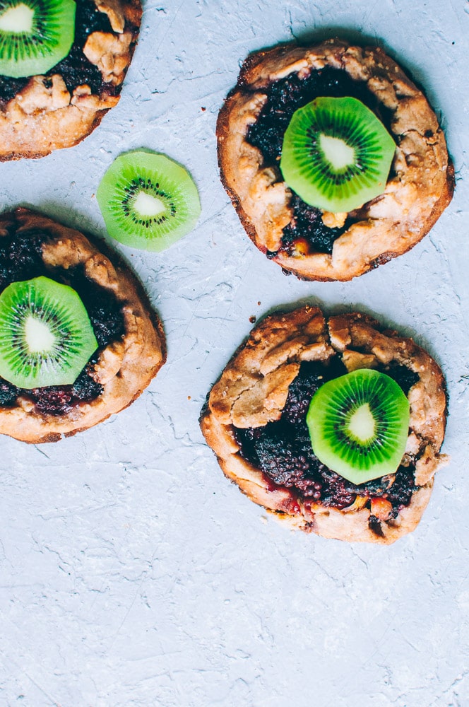  How-to make Mini Blackberry Kiwi Galettes -  These gluten-free vegan mini rustic pies are filled with juicy blackberries and tart kiwi for a fun twist! Easy, healthy, and delicious galettes are at your fingertips! #galette #galettes #minipies #rusticepies #kiwi #blackberries #glutenfreepie #veganpie #kiwipie  