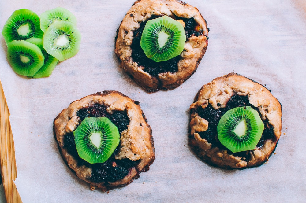  How-to make Mini Blackberry Kiwi Galettes -  These gluten-free vegan mini rustic pies are filled with juicy blackberries and tart kiwi for a fun twist! Easy, healthy, and delicious galettes are at your fingertips! #galette #galettes #minipies #rusticepies #kiwi #blackberries #glutenfreepie #veganpie #kiwipie  